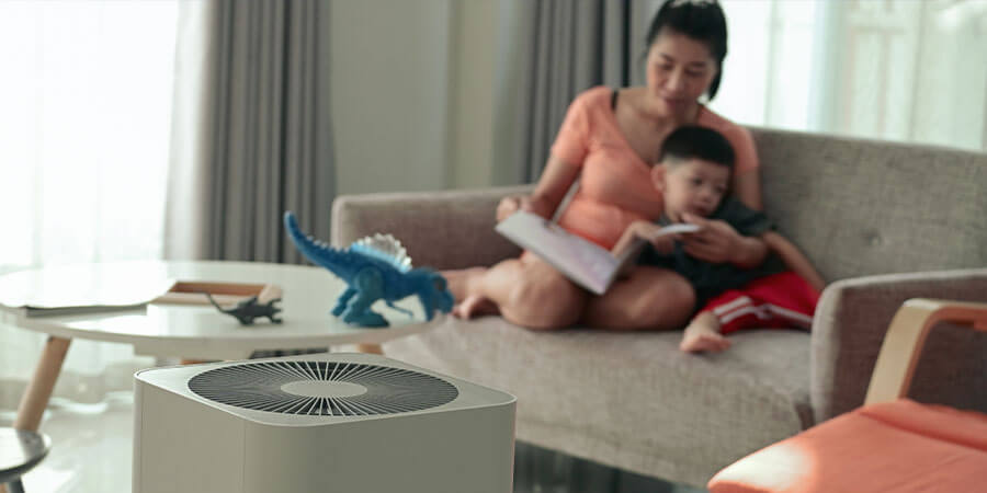 Mother and son sitting together with a humidifier on