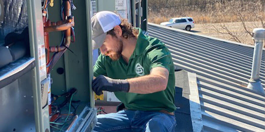 Springfield Heating and Air technician working on a light commerical unit