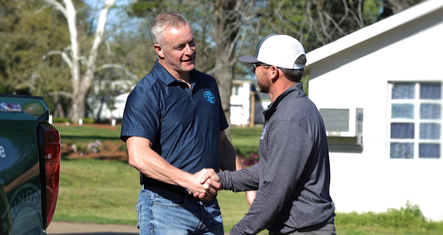 two men shake hands